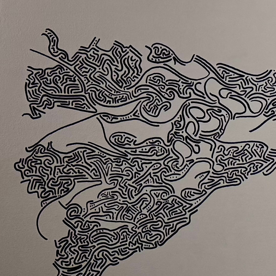 Closeup of black linework spreading across the ceiling surface