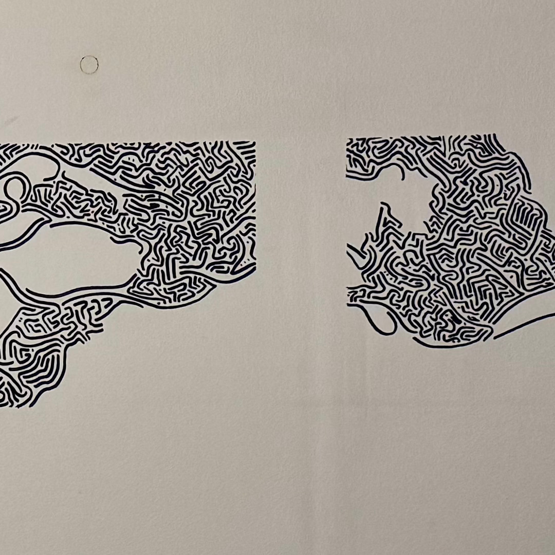 Two separated fragments of black mural linework on a pale ceiling
