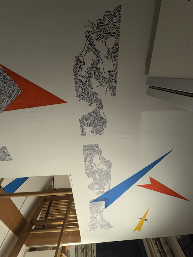 Wide interior view showing the mural decoration installed across the ceiling