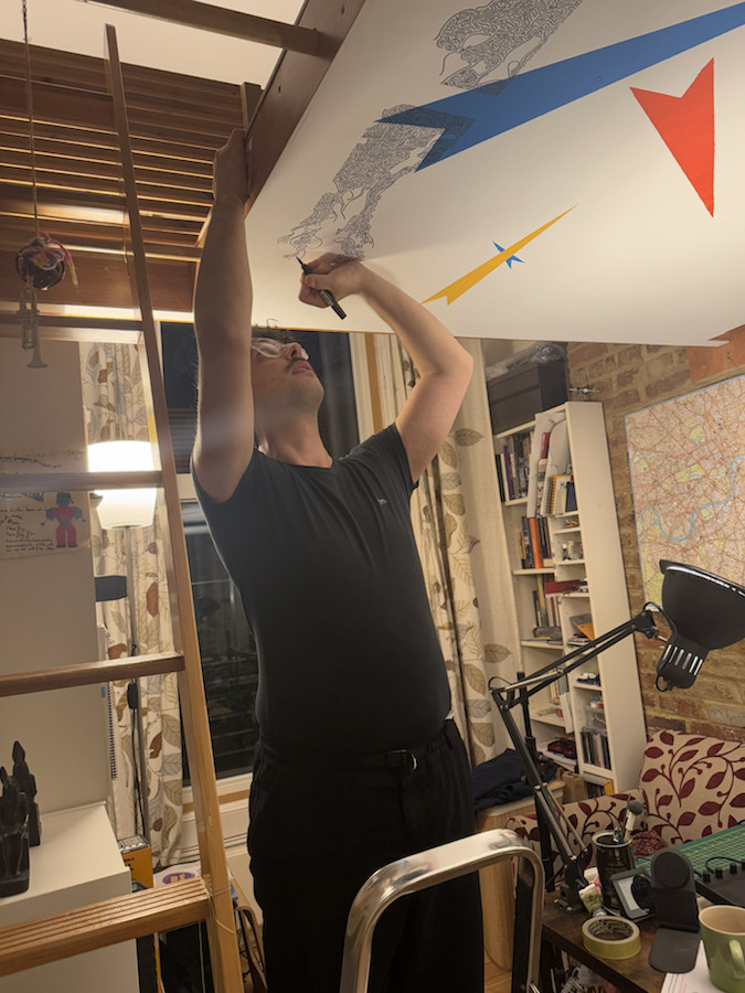Documentation image showing the mural being painted on the ceiling