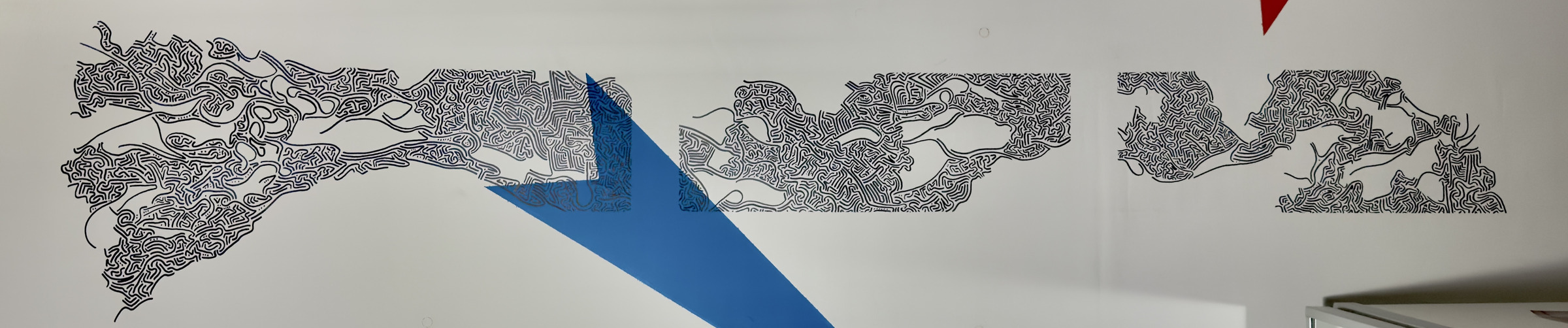 Interior ceiling mural with black linework and a blue geometric arrow