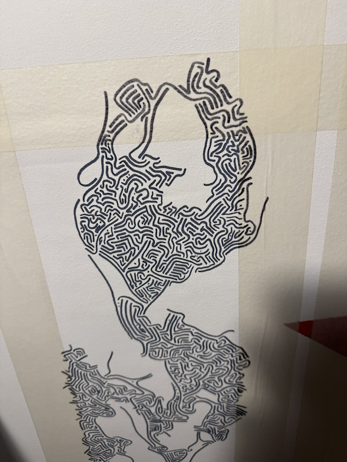 Process closeup of a dark linework shape on a taped ceiling section