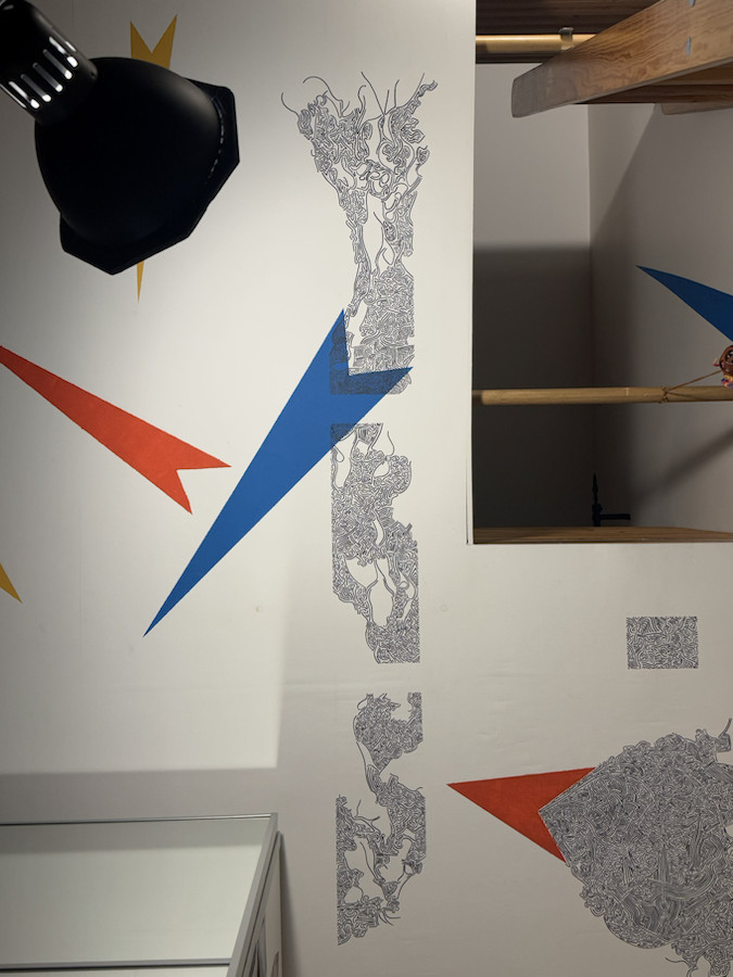 Ceiling view showing several mural studies, arrows and painted linework panels together
