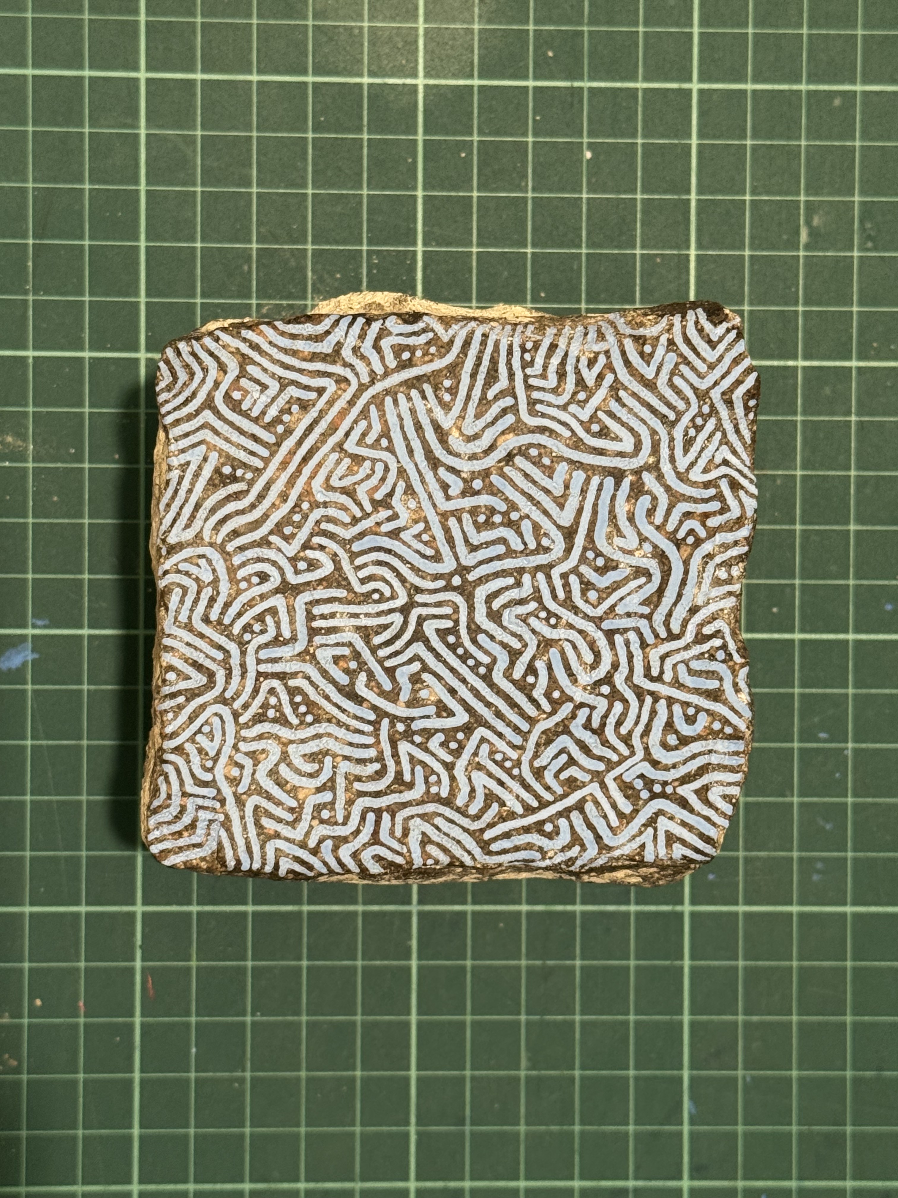 Top view of pale blue linework painted on a sanpietrino